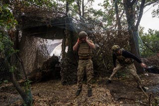 Service members of the 13th Operative Purpose Brigade 'Khartiia' of the National Guard of Ukraine fire an M101 howitzer towards Russian troops, at a position in a front line, amid Russia's attack on Ukraine, in Kharkiv region